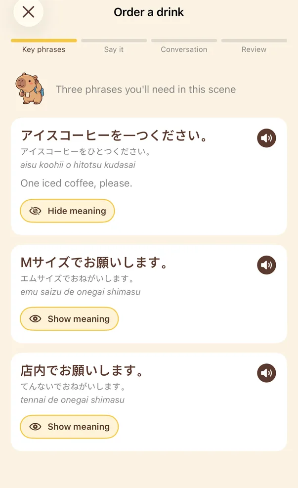 Key phrases screen: three Japanese phrases with kana and romaji readings. The first one shows its meaning, “One iced coffee, please.”